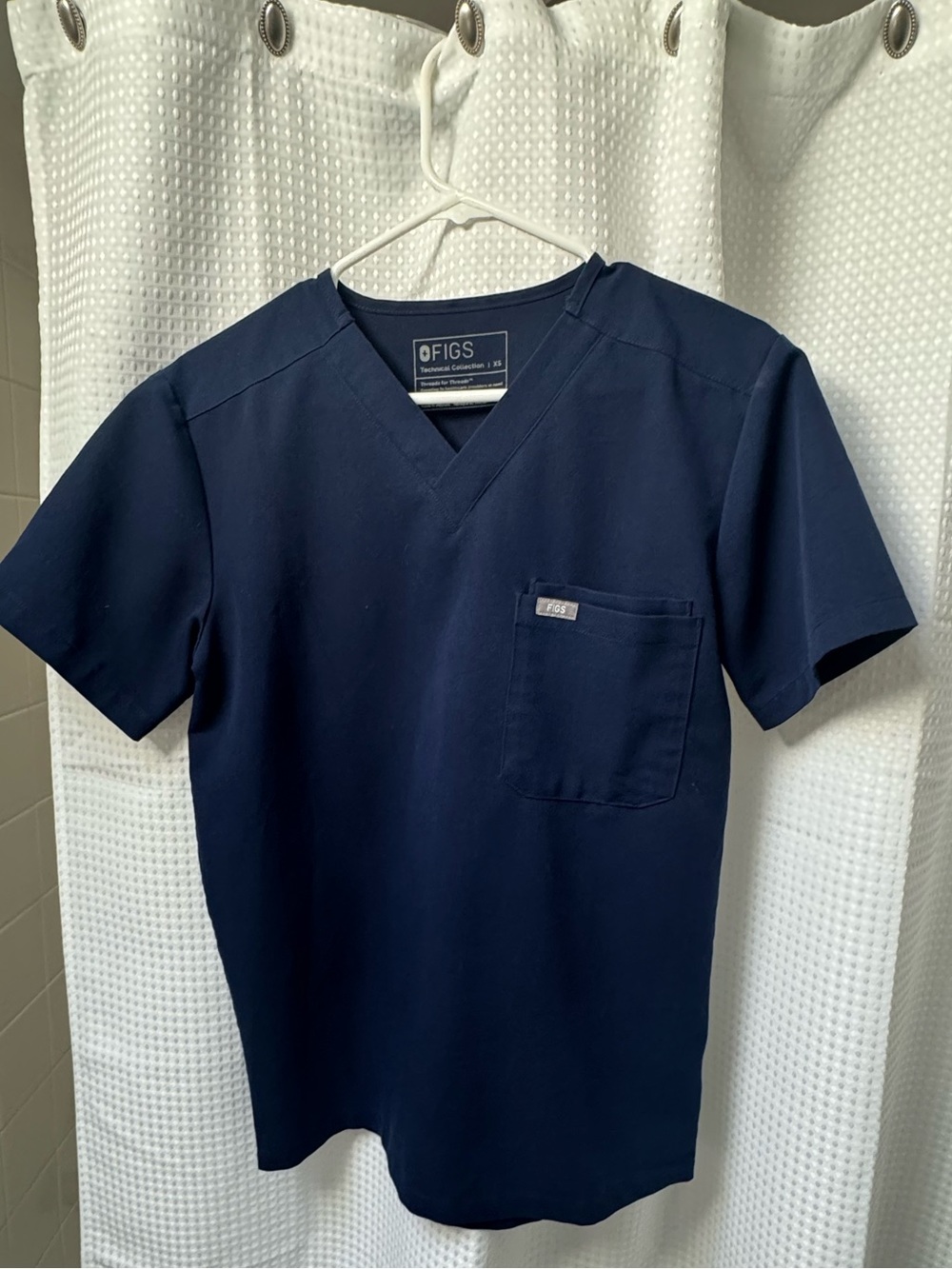 FIGS Womels Scrub Set in Navy Blue  
V Neck Top  is XS. Zipper Pants XS/S